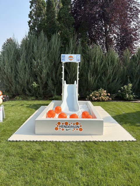 Basketball-themed ball pit and slide on the lawn