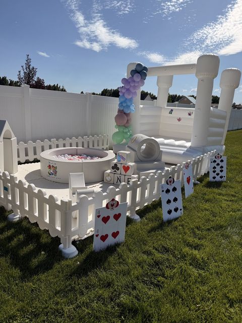 Wide view of an Alice in Wonderland party setup with playing card decorations